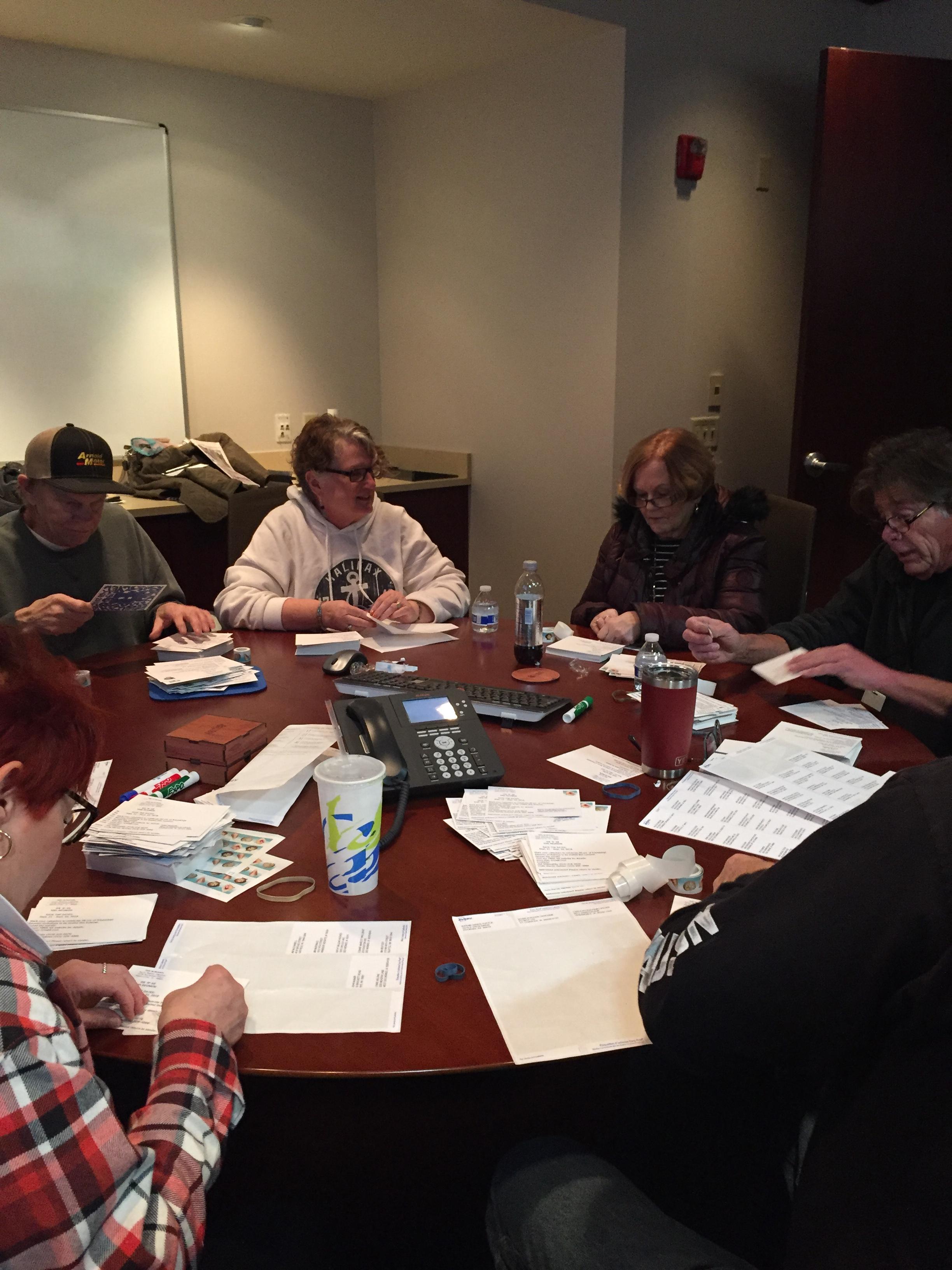 Your committee getting the save-the-date cards ready to mail.